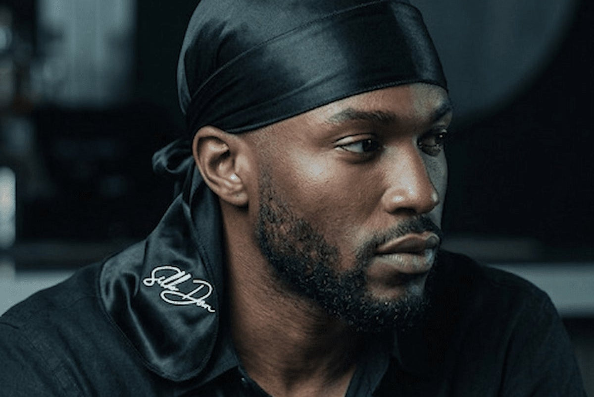 Man wearing a black SilkDon Durag and black shirt.