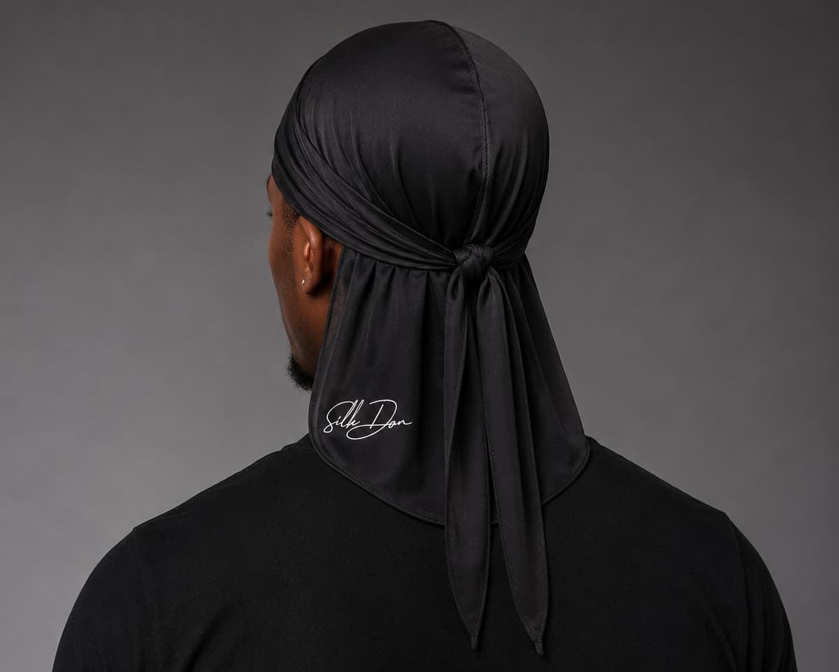 Person wearing a black SilkDon with a brand logo on a gray background