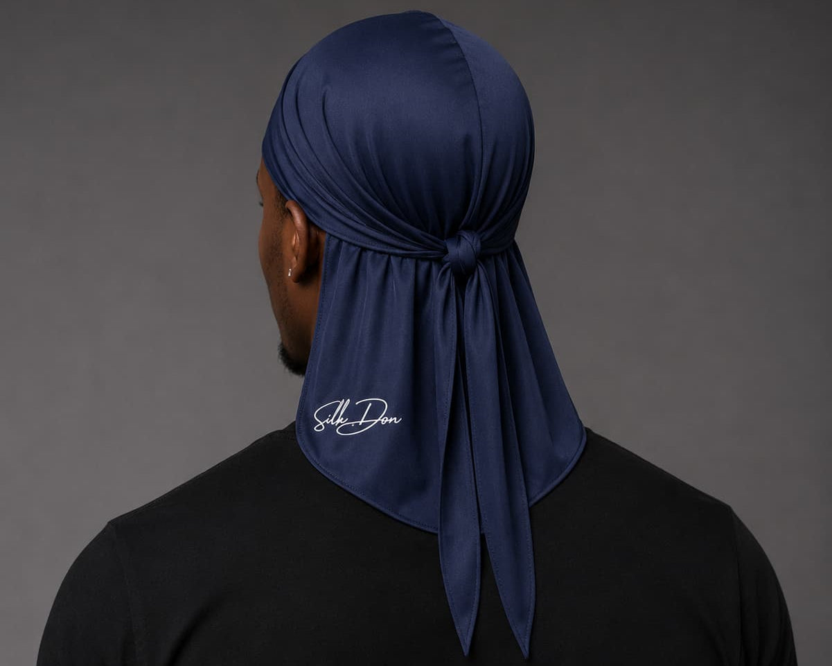Person wearing a navy blue durag with a SilkDon logo on a gray background