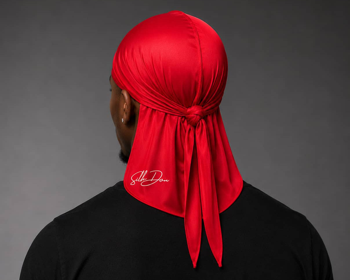 Person wearing a red durag with a SilkDon logo on a gray background