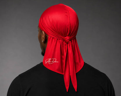 Person wearing a red durag with a SilkDon logo on a gray background
